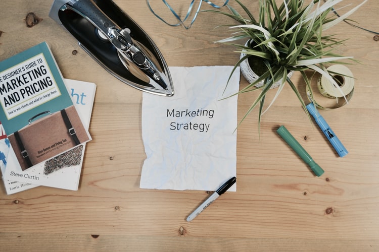 iron on a crinkle page that reads "marketing strategy"