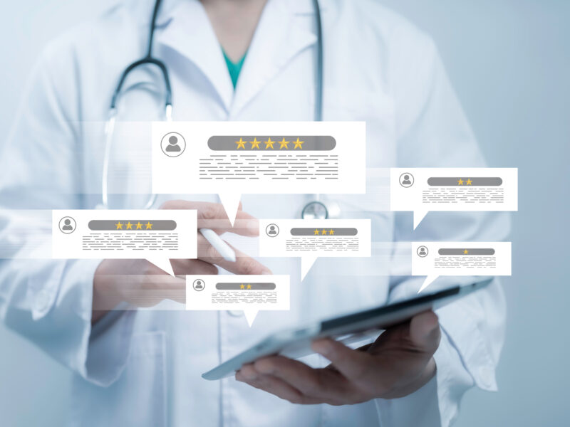 doctor holding tablet with overlay of online ratings of medical practice